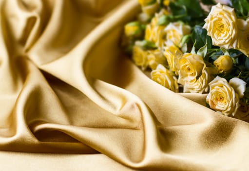 Yellow roses on gold silk background