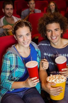 Young couple watching a film at the cinema