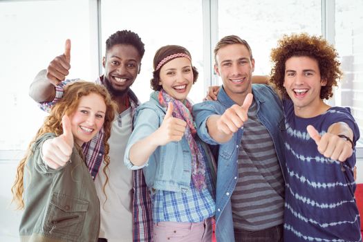 Fashion students smiling at camera together at the college