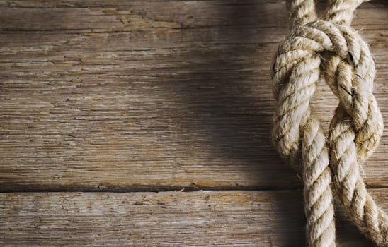 Old wood with rope knot