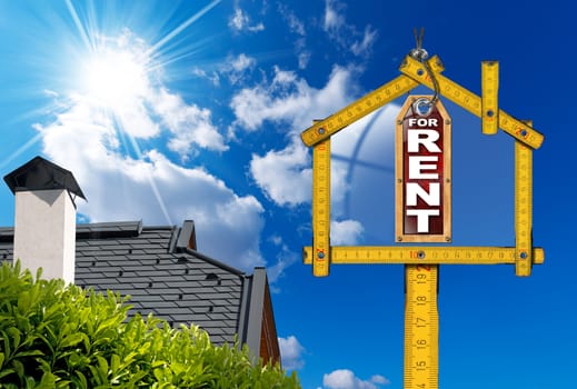 Yellow wooden meter ruler in the shape of house and label with text for rent. For rent real estate sign on blue sky with roof, clouds and sun rays