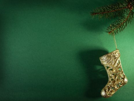 Christmas gold stocking on green background
