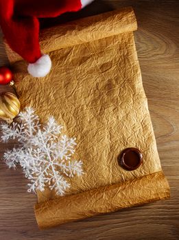 Letter for Santa with christmas hat on wood background