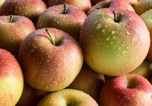 Apples with water drops, food background