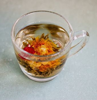 exotic green tea with flowers in glass cup