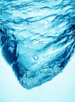 Whirpool underwater in blue clean transparent water