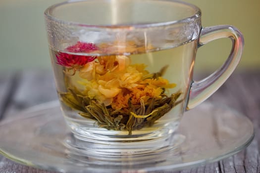 exotic green tea with flowers in glass cup