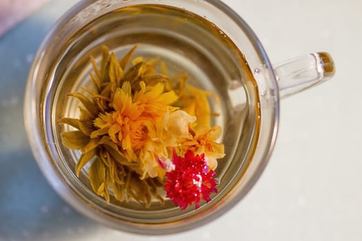 exotic green tea with flowers in glass cup