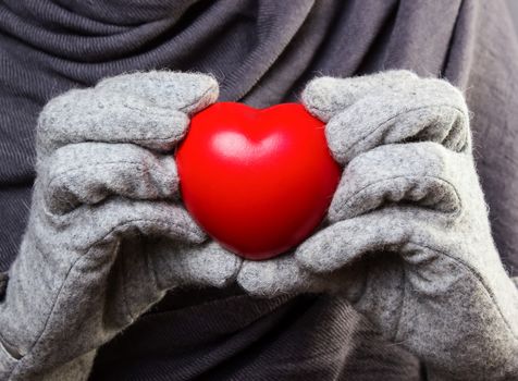 Red heart in woman hands