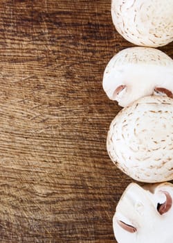 Fresh champignon on wood background