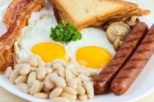 English breakfast: eggs, beans, sausages, bacon and mushrooms