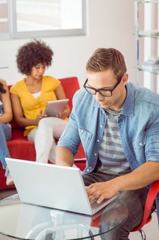 Fashion student using his laptop at the college