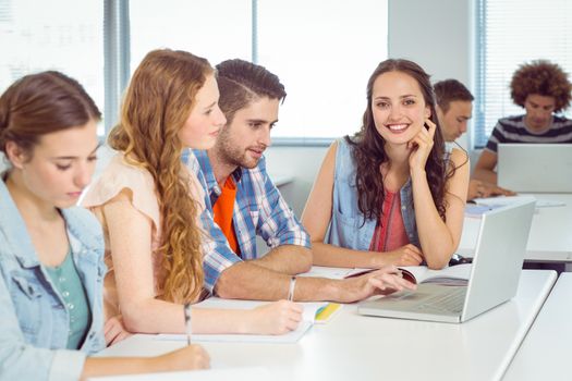 Fashion student smiling at camera at the college