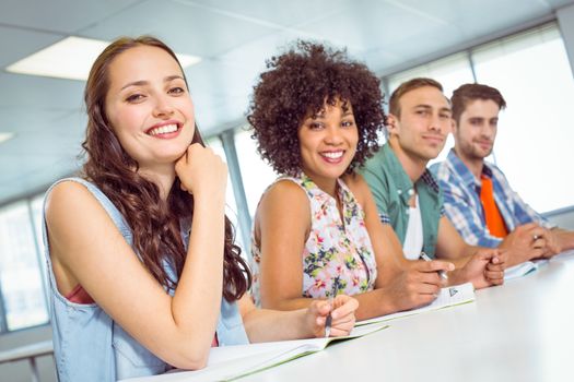 Fashion student smiling at camera at the college