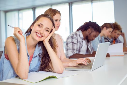 Fashion student smiling at camera at the college