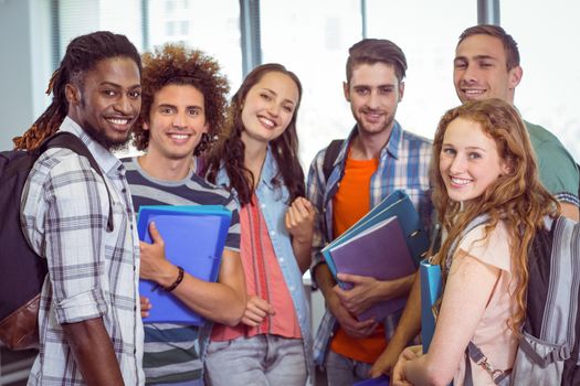 Fashion students smiling at camera together at the college