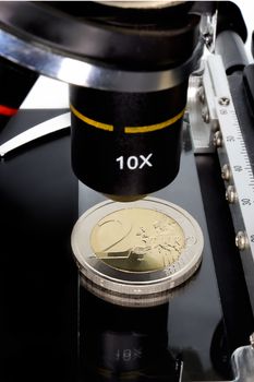 Euro currency in check under the microscope.