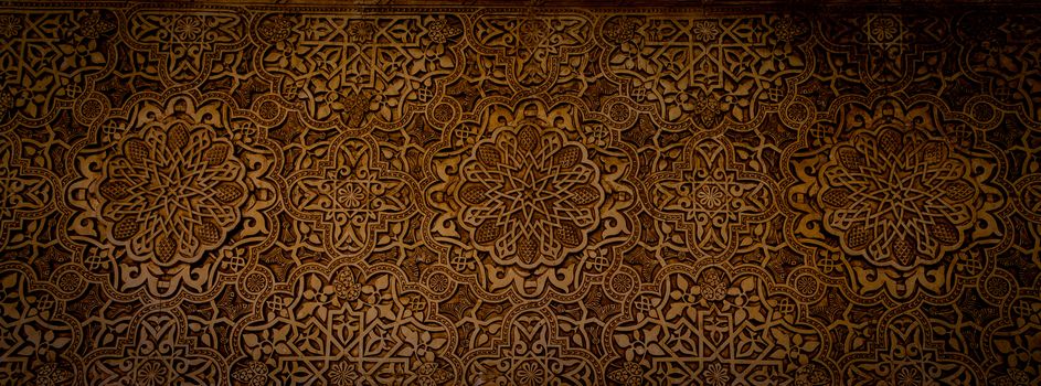 Wall detail of Alhambra UNESCO site in Granada - South of Spain. 600 years old arabic characters.