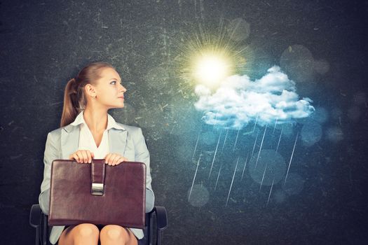 Young Businesswoman Sitting in Chair with Briefcase in Lap, Looking to the Side at Illustration of Weather in Aspirational Concept Image