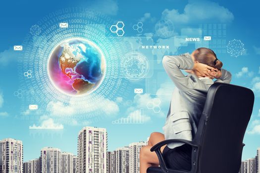 Businesswoman with Hands Behind Head Leaning Back in Office Chair and Looking Out at City Skyline with Digital Technology Globe Hovering in Sky