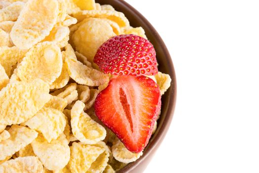 Close up view of bowl with cornflakes and strawberries isolated on white background