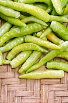 pile of green thai goat pepper on bamboo plate