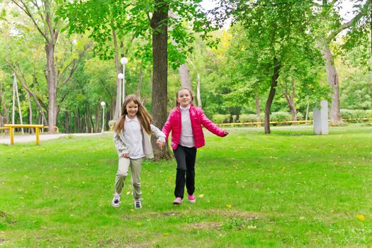 Photo of cute two running girls in summer