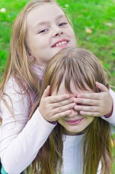 Photo of two playing girls in summer