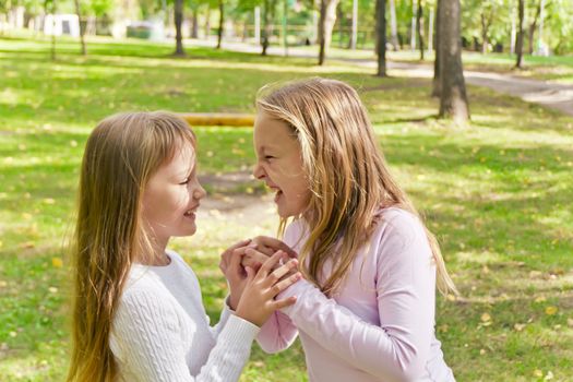 Photo of two playing girls in summer