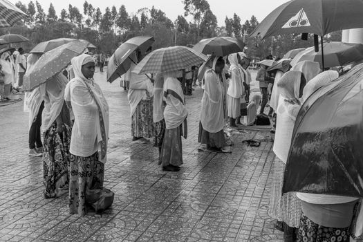 Addis Ababa: April 10: Devoted Ethiopian Orthodox followers stand undeterred by the pouring rain to observe Siklet, the crucifixion of Jesus Christ, at Bole Medhane Alem Church on April 10 ,2015 in Addis Ababa, Ethiopia