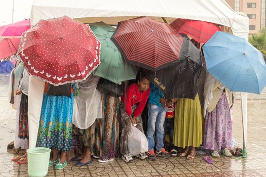 Addis Ababa: April 10: Devoted Ethiopian Orthodox followers stand undeterred by the pouring rain to observe Siklet, the crucifixion of Jesus Christ, at Bole Medhane Alem Church on April 10 ,2015 in Addis Ababa, Ethiopia