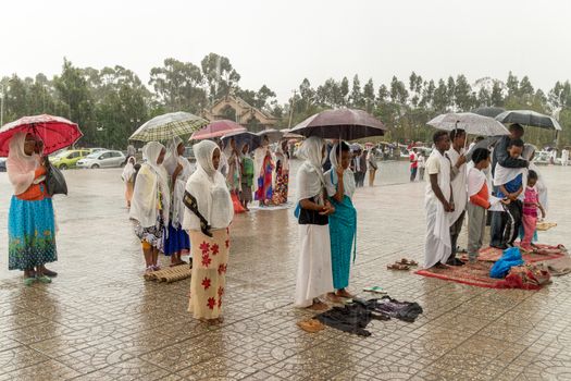 Addis Ababa: April 10: Devoted Ethiopian Orthodox followers stand undeterred by the pouring rain to observe Siklet, the crucifixion of Jesus Christ, at Bole Medhane Alem Church on April 10 ,2015 in Addis Ababa, Ethiopia