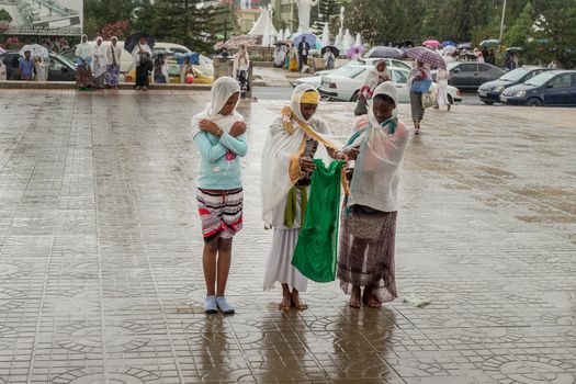 Addis Ababa: April 10: Devoted Ethiopian Orthodox followers stand undeterred by the pouring rain to observe Siklet, the crucifixion of Jesus Christ, at Bole Medhane Alem Church on April 10 ,2015 in Addis Ababa, Ethiopia