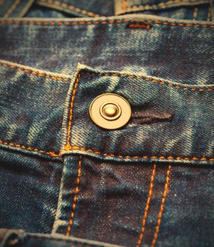part of blue jeans with button, close up. instagram image retro style