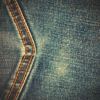 aged jeans background with seam, close up. instagram image style