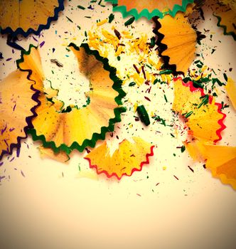 colored pencil shavings on white background with copy space. instagram image retro style