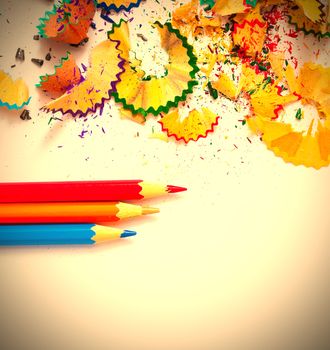 colored pencils and shavings on white background with copy space. instagram image retro style