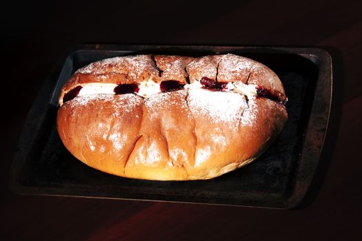 Raspberry jam and cream pastry on a baking tray
