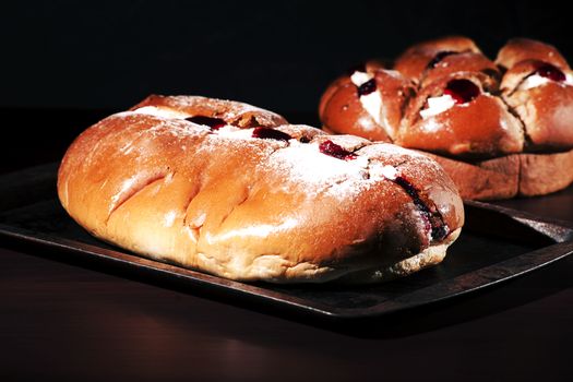 Raspberry jam and cream pastry on a baking tray