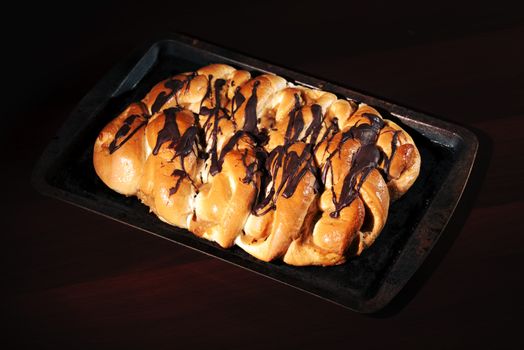 Chocolate and caramel danish pastry on a baking tray