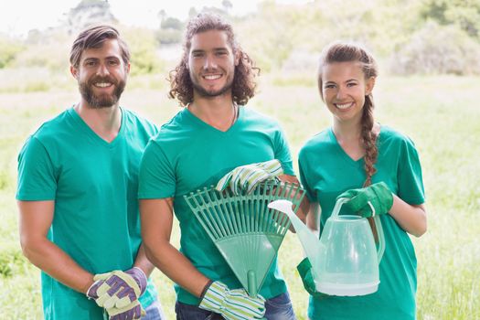 Happy friends gardening for the community on a sunny day