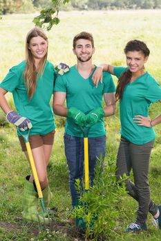 Happy friends gardening for the community on a sunny day