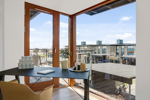 Modern home office with views through large windows