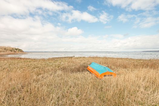 Bightly painted boat on a grass field in Roskilde Denmark