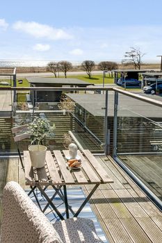 Bright balcony with furniture in a modern danish home