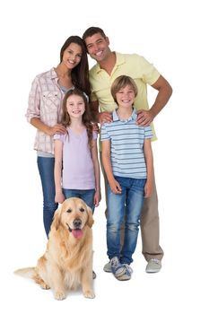 Portrait of happy family standing with dog over white background