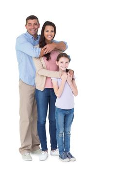 Portrait of happy family embracing each other over white background