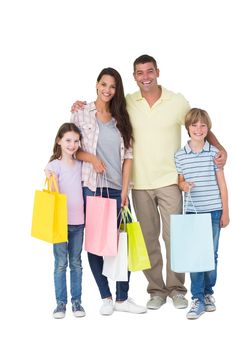 Portrait of happy family carrying shopping bags over white background