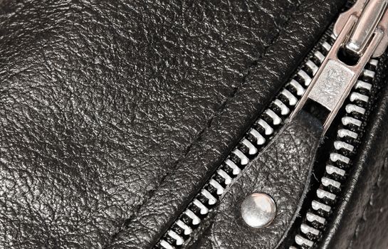 Part black leather clothing with a zipper. macro photo