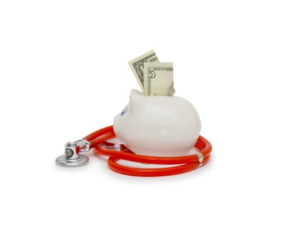 piggy bank with stethoscope isolated on white